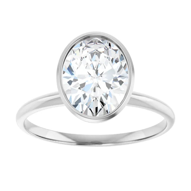 Top view of a 14K white gold engagement ring setting. The setting has a polished band and a delicate bezel that wraps securely around the base of a simulated oval diamond (center stone not included).