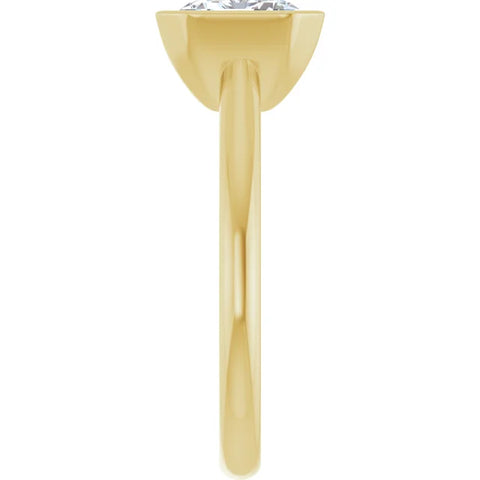 Side view of a 14K yellow gold engagement ring.  The ring features  a gleaming emerald cut diamond held securely in a half bezel setting, revealing a clear view of the diamond's elongated facets.