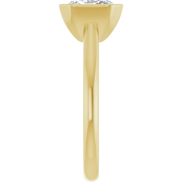 Side view of a 14K yellow gold engagement ring.  The ring features  a gleaming emerald cut diamond held securely in a half bezel setting, revealing a clear view of the diamond's elongated facets.